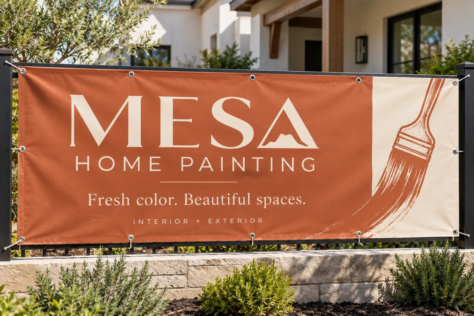 Mesa Home Painting printed vinyl banner with grommets mounted on a fence